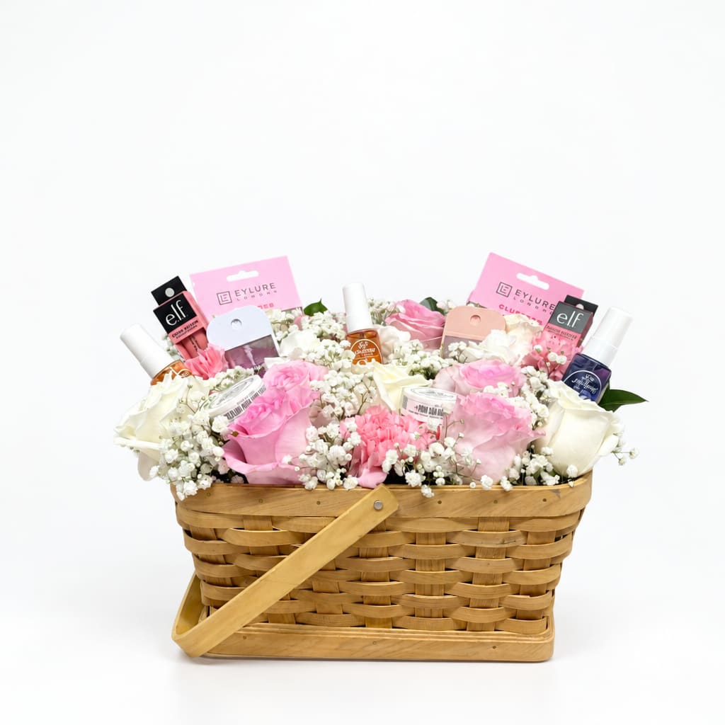 Basket arrangement of pink and white roses with cosmetics and nail products