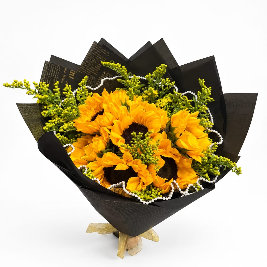 Bouquet of yellow sunflowers wrapped in black paper with a gold ribbon