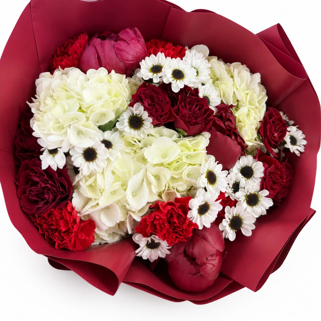 Bouquet of red, white, and cream flowers wrapped in burgundy paper
