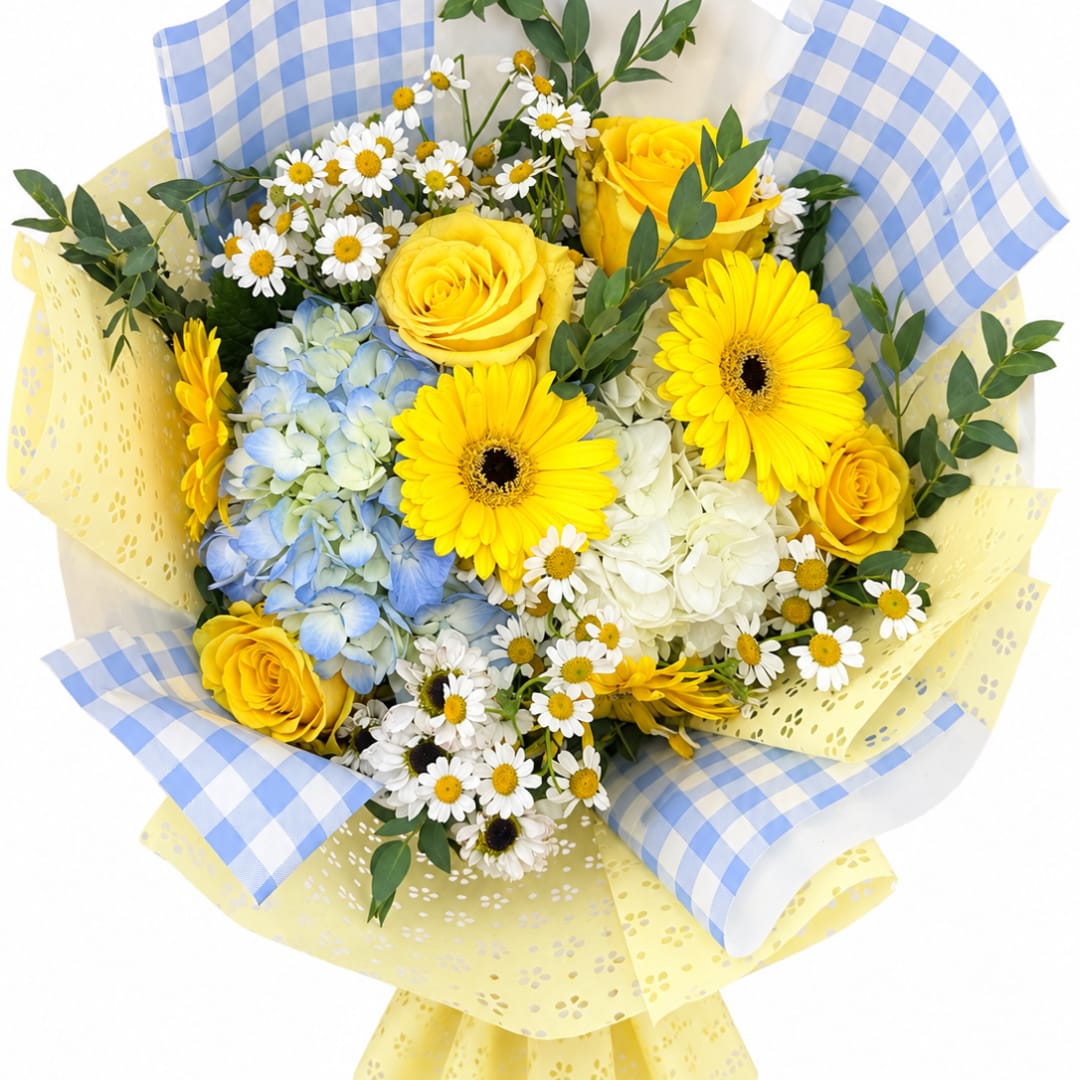 Bouquet of yellow roses, gerbera daisies, blue hydrangea, and white daisies