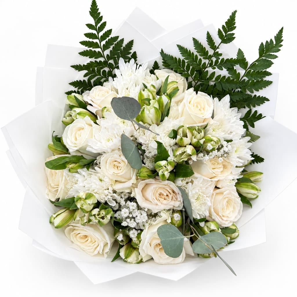 White roses and chrysanthemums in white wrapping with green foliage