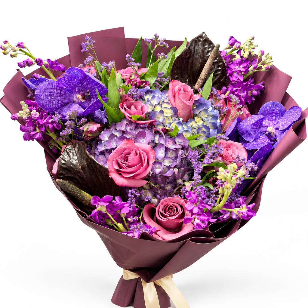 Bouquet of pink roses, purple orchids, and hydrangeas wrapped in dark paper