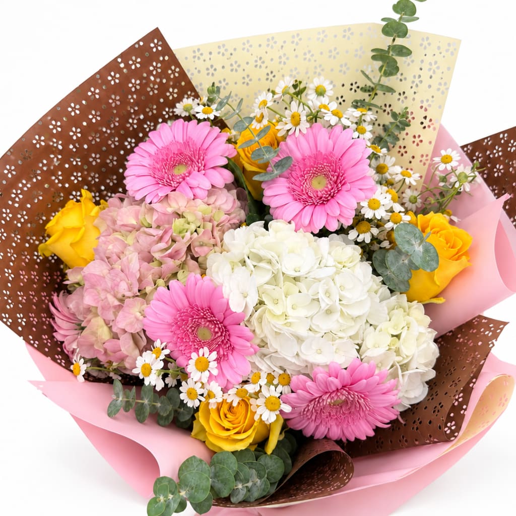 Bouquet of pink gerberas, white hydrangea, yellow roses, and small daisies