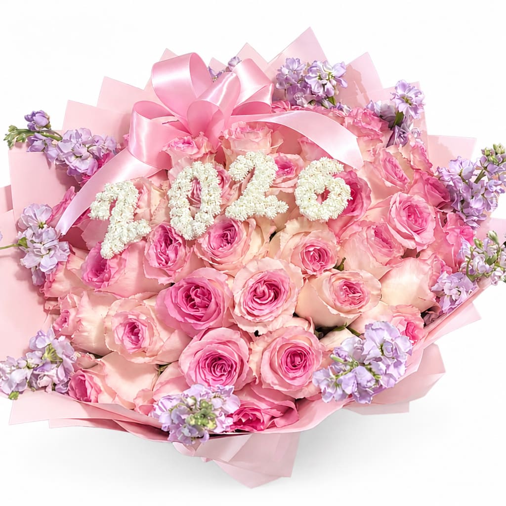 Pink rose bouquet with lavender accents and a large pink ribbon