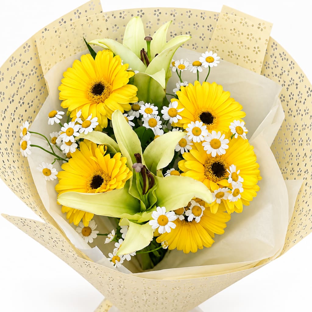 Yellow gerbera daisies and white lilies with small daisies in wrapped bouquet