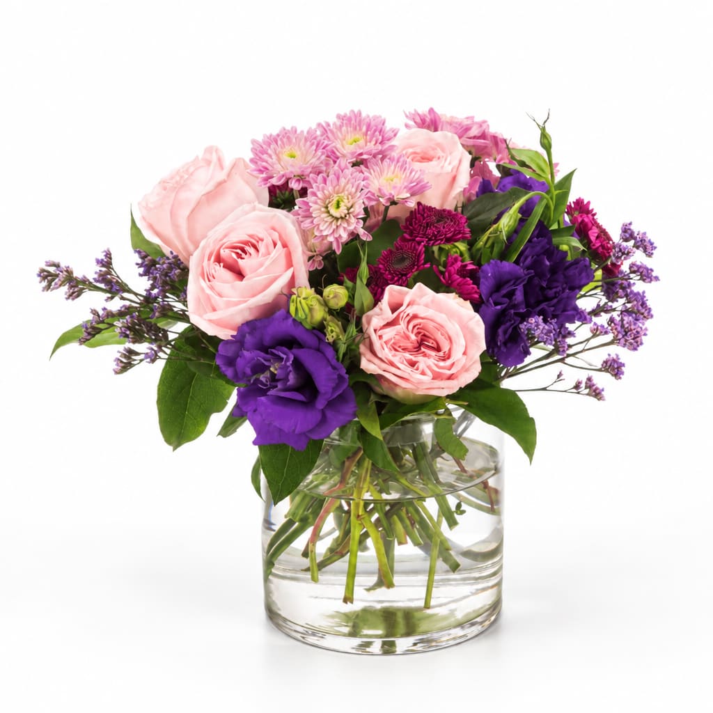 Pink and purple mixed bouquet in a clear glass vase