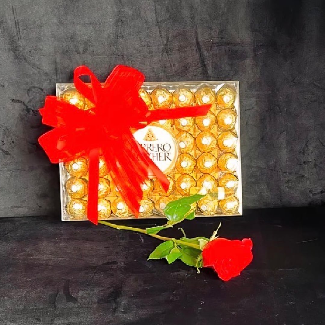 Box of Ferrero Rocher chocolates with a red bow and a red rose