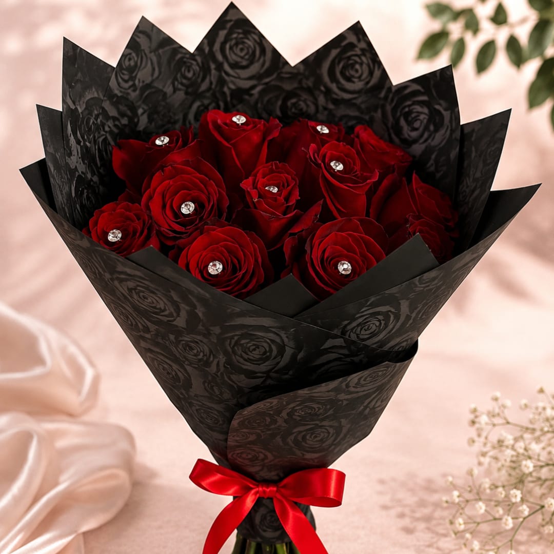 Bouquet of red roses wrapped in black paper with a red ribbon