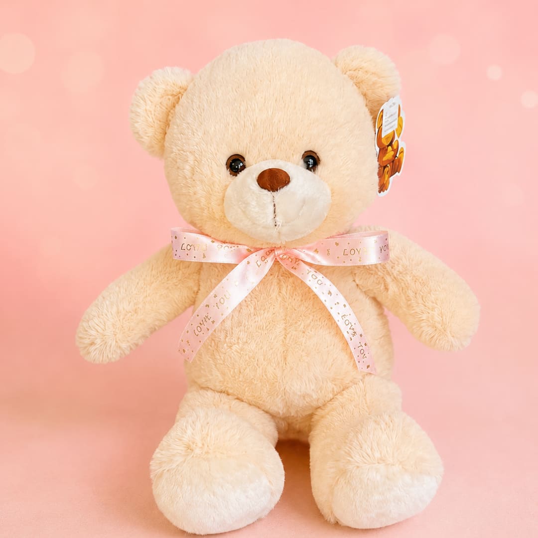 Cream teddy bear with a pink ribbon on a pink background