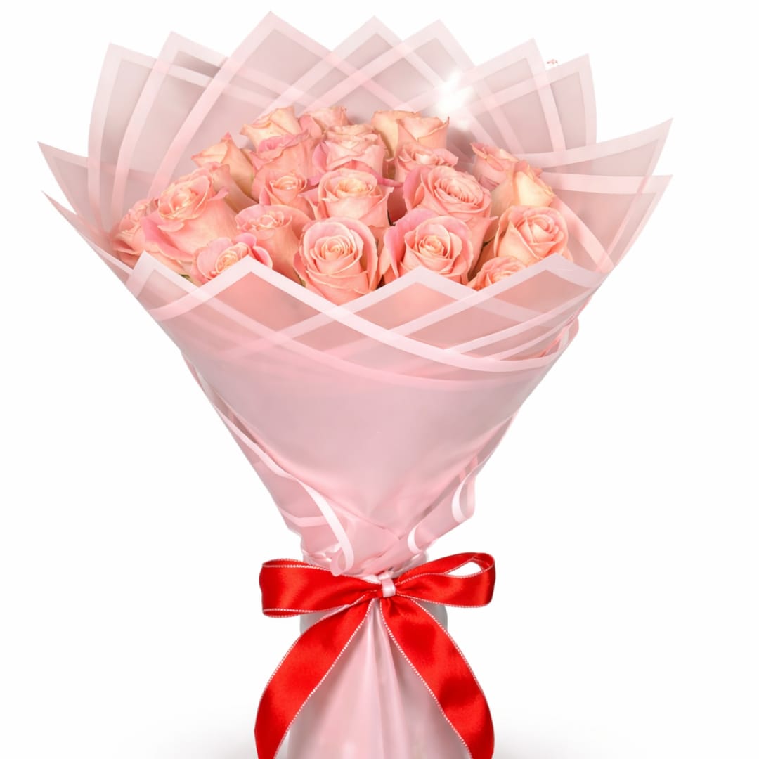 Bouquet of pale pink roses wrapped in pink paper with a red ribbon