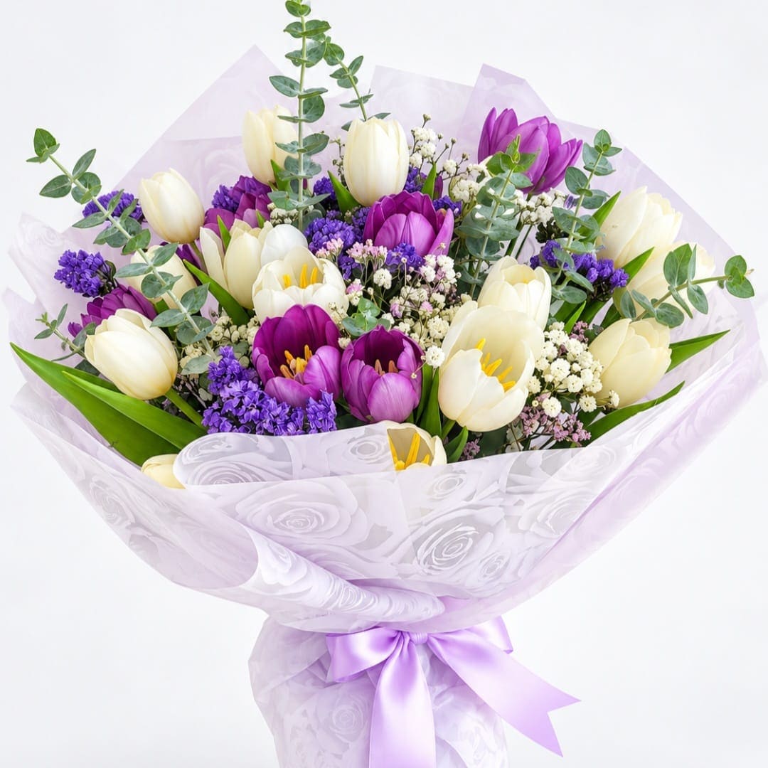 Bouquet of purple and white tulips wrapped in lavender paper