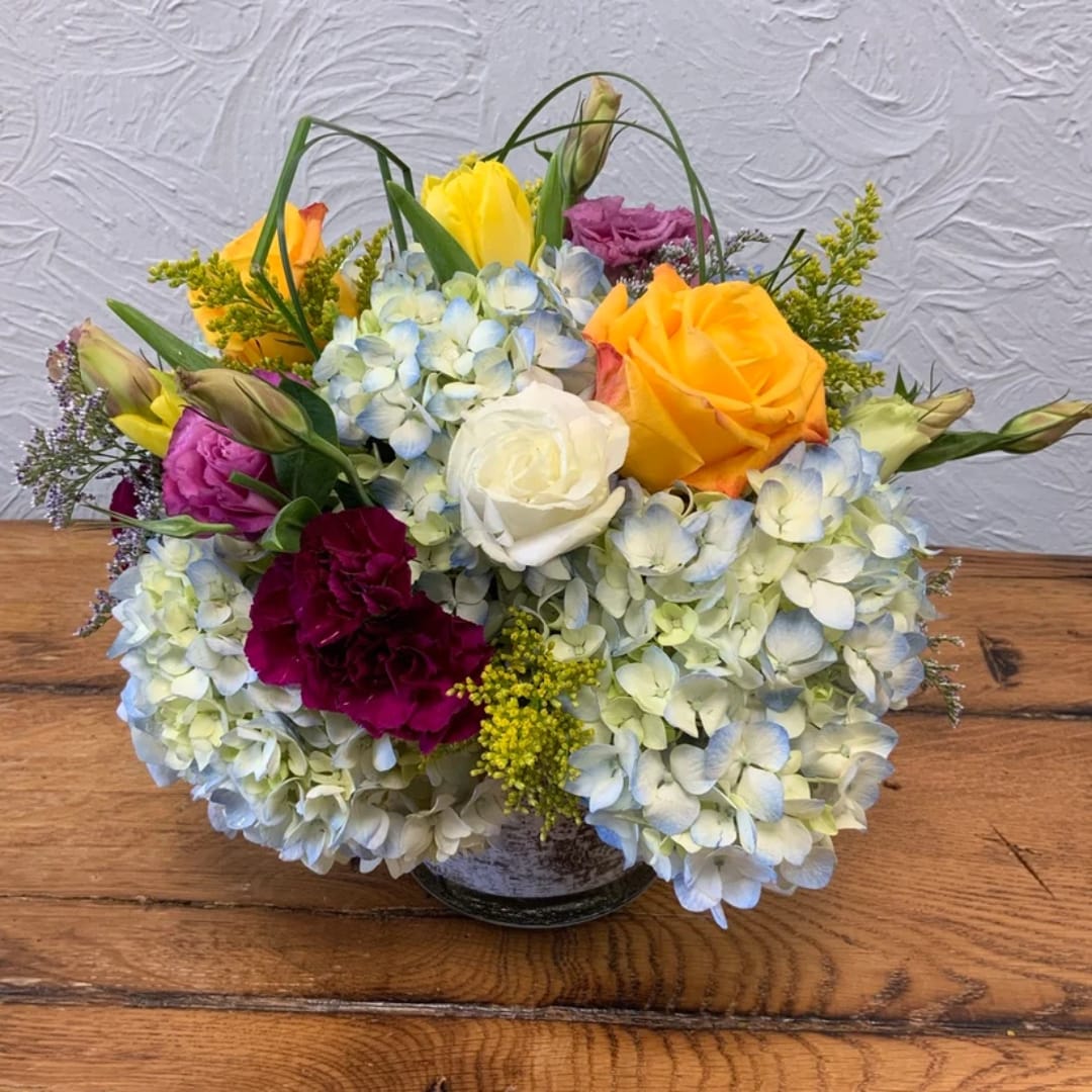 Mixed bouquet with hydrangeas, roses, and carnations in a vase