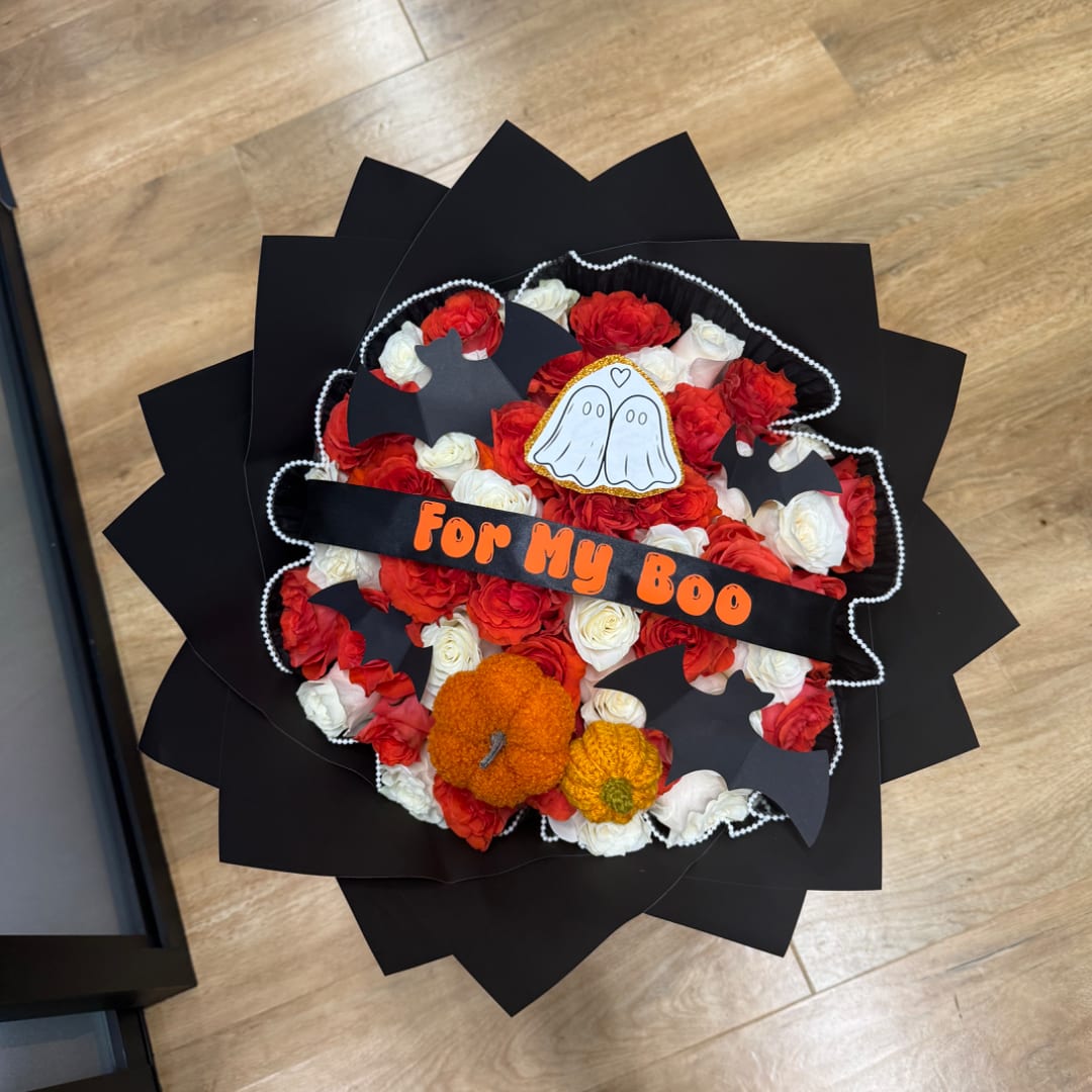 Halloween bouquet of red and white roses with bat cutouts and pumpkin accents