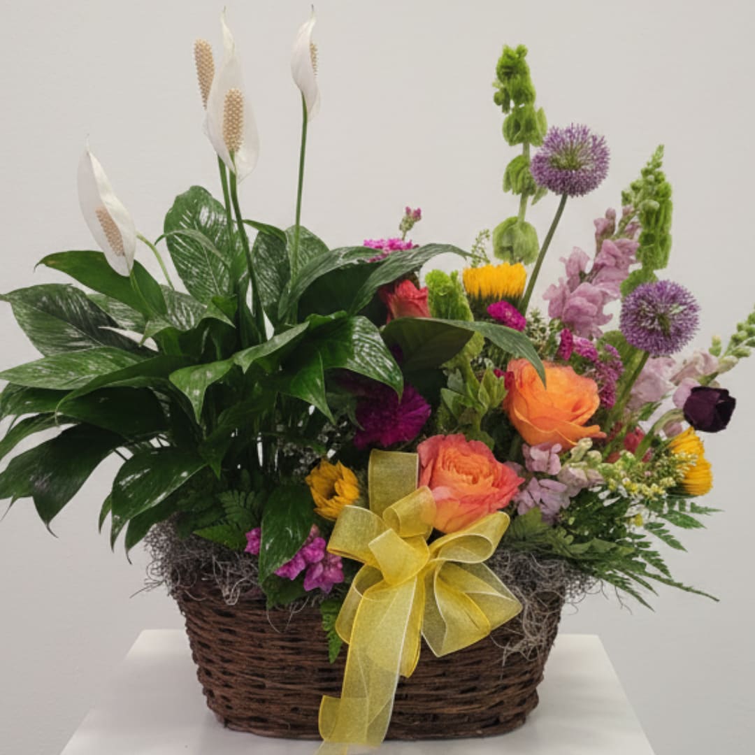 Mixed floral basket with white peace lilies, orange roses, and purple blooms