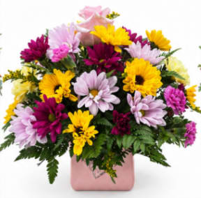 Mixed pink, yellow, and purple flowers in a pink vase