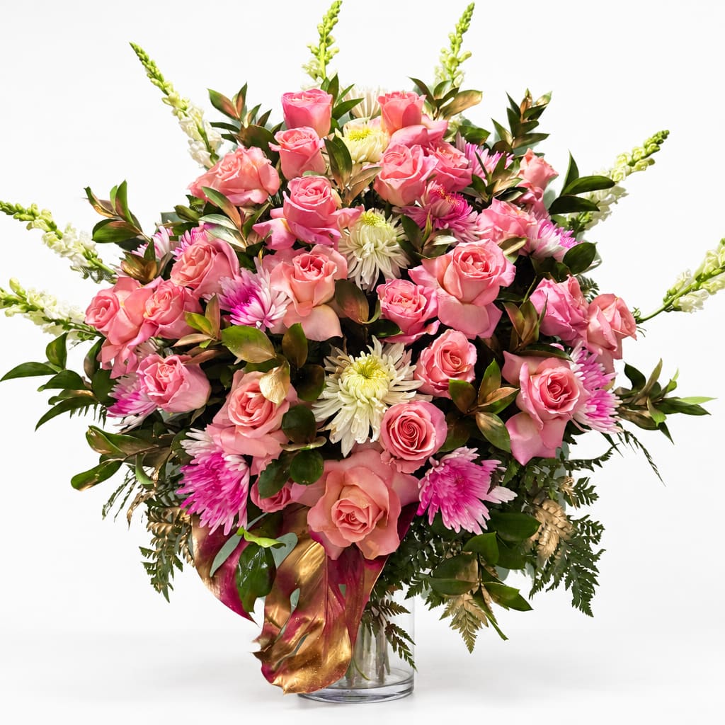 Pink roses and white chrysanthemums in a clear glass vase