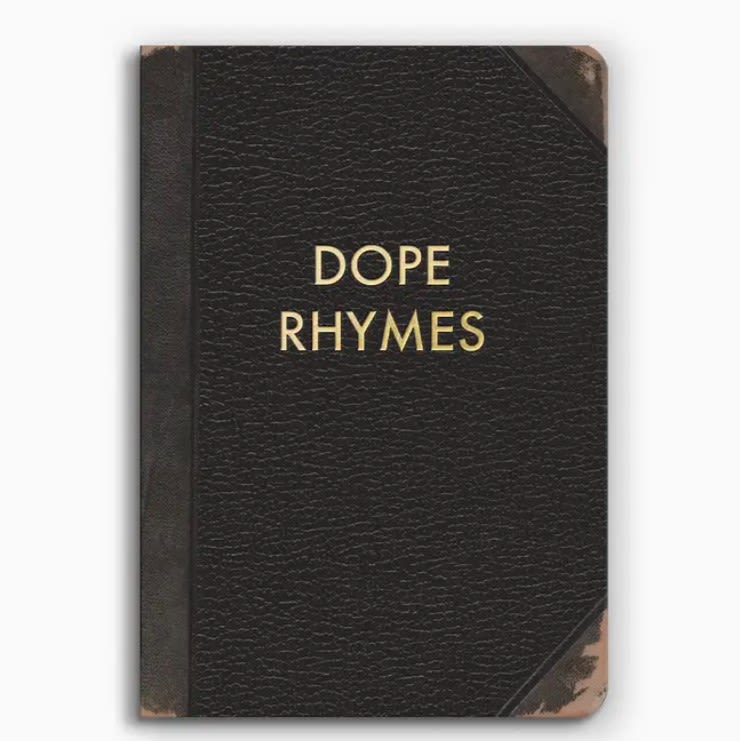 Black book with gold text reading Dope Rhymes