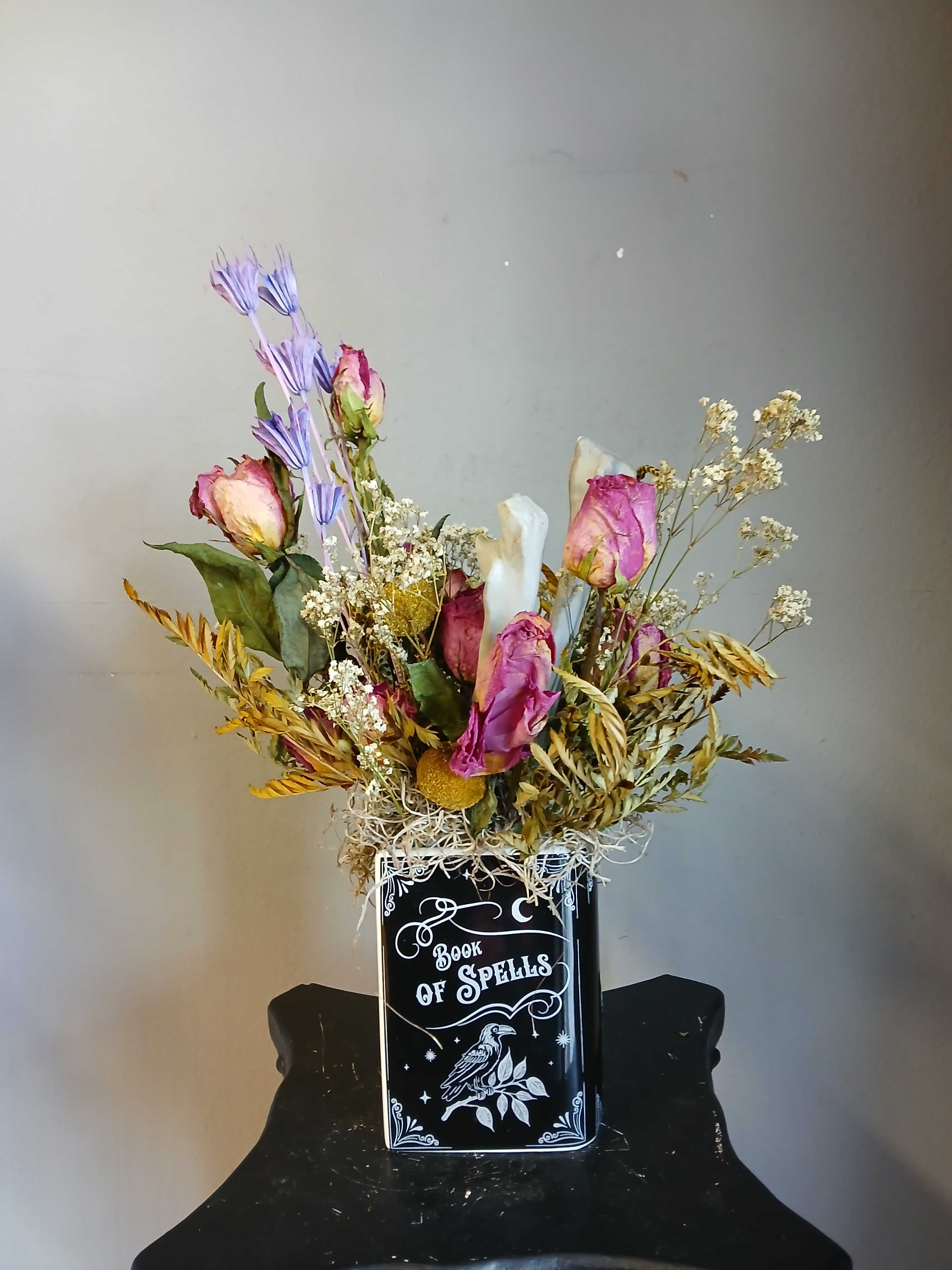 Dried Flower Bouquet #5 in seasonal vase - Bring a touch of magic to your floral arrangements with this ceramic flower vase, styled to resemble a mystical "Book of Spells." A charming gift for witches, book lovers, or anyone looking to perfect their gothic-inspired decor.