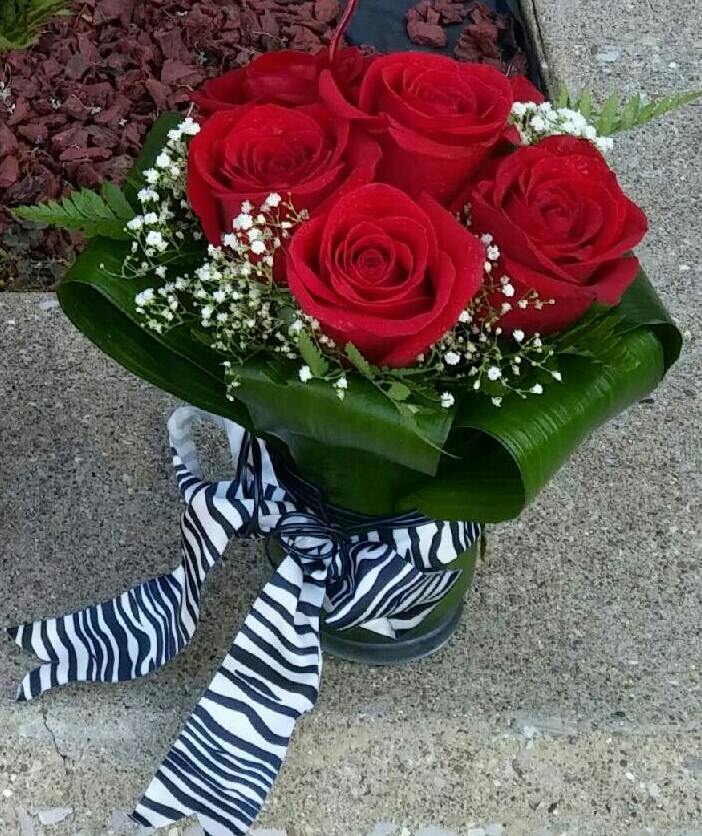 Bouquet of red roses with baby's breath and a striped ribbon
