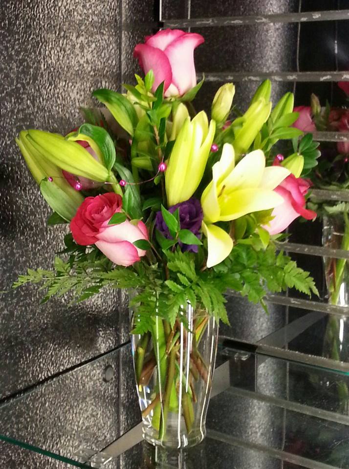 Bouquet of lilies and roses in a clear glass vase