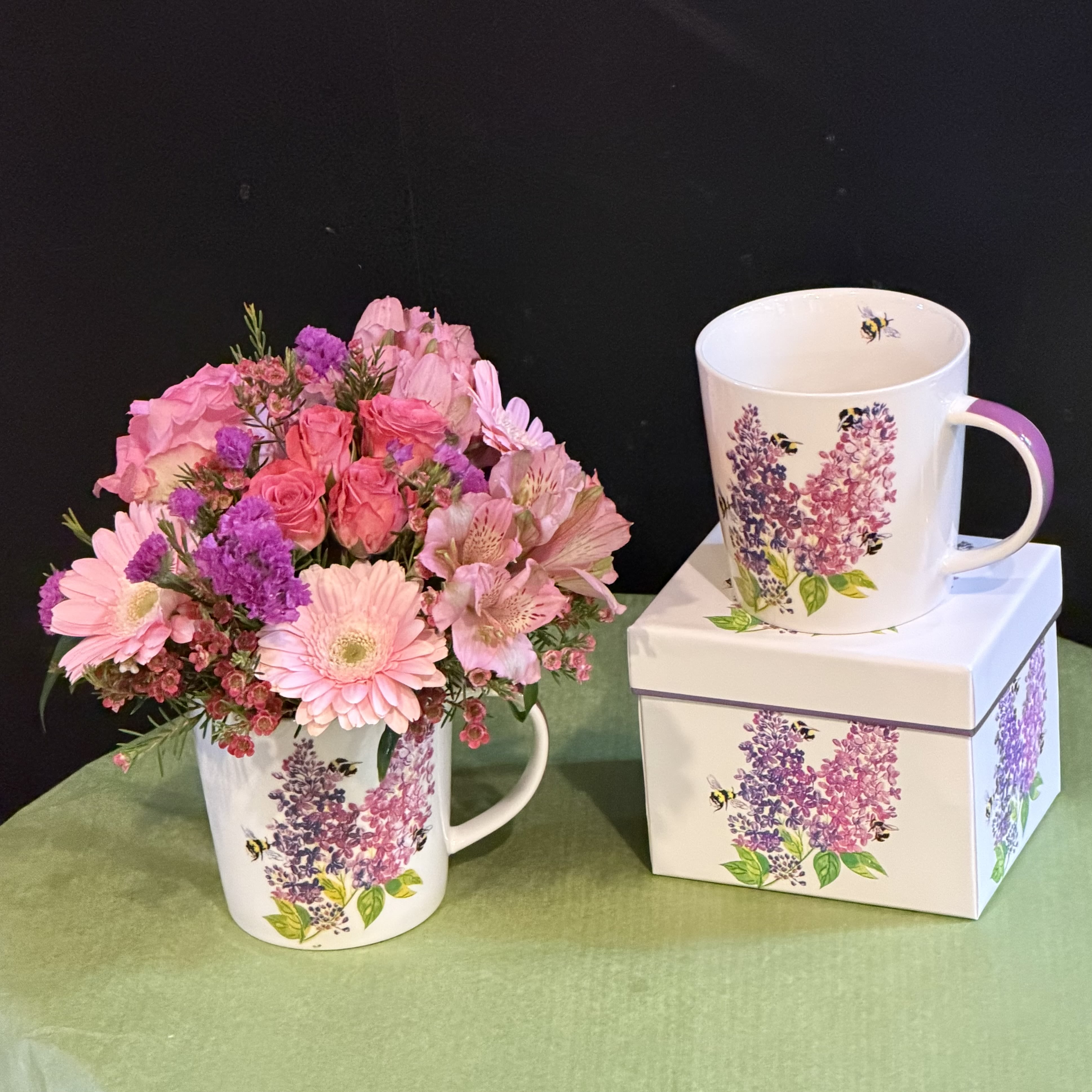 Lilac Mug - Soft and romantic arrangement in a floral lilac-themed mug, filled with pink and purple blooms. A timeless gift with a reusable mug that is microwave and dishwasher safe.