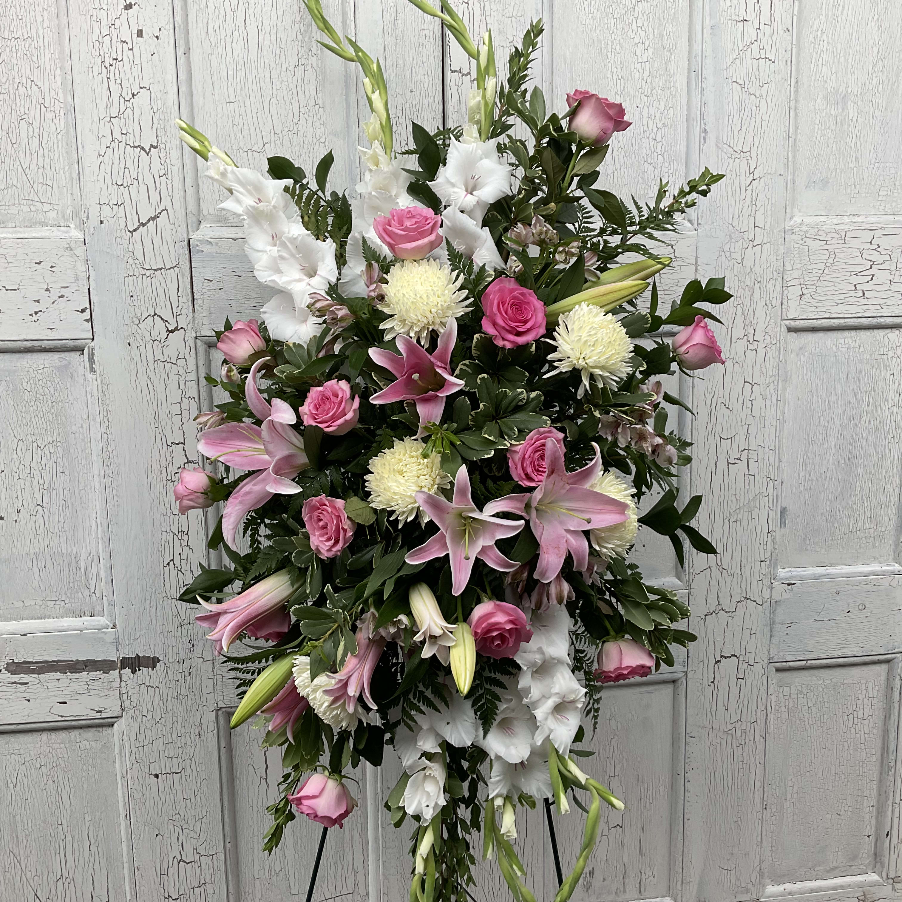 Standing floral spray with pink roses, white lilies, and white mums