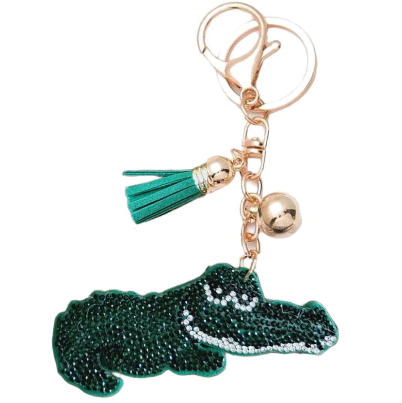 Alligator-shaped keychain with a green beaded charm and gold hardware