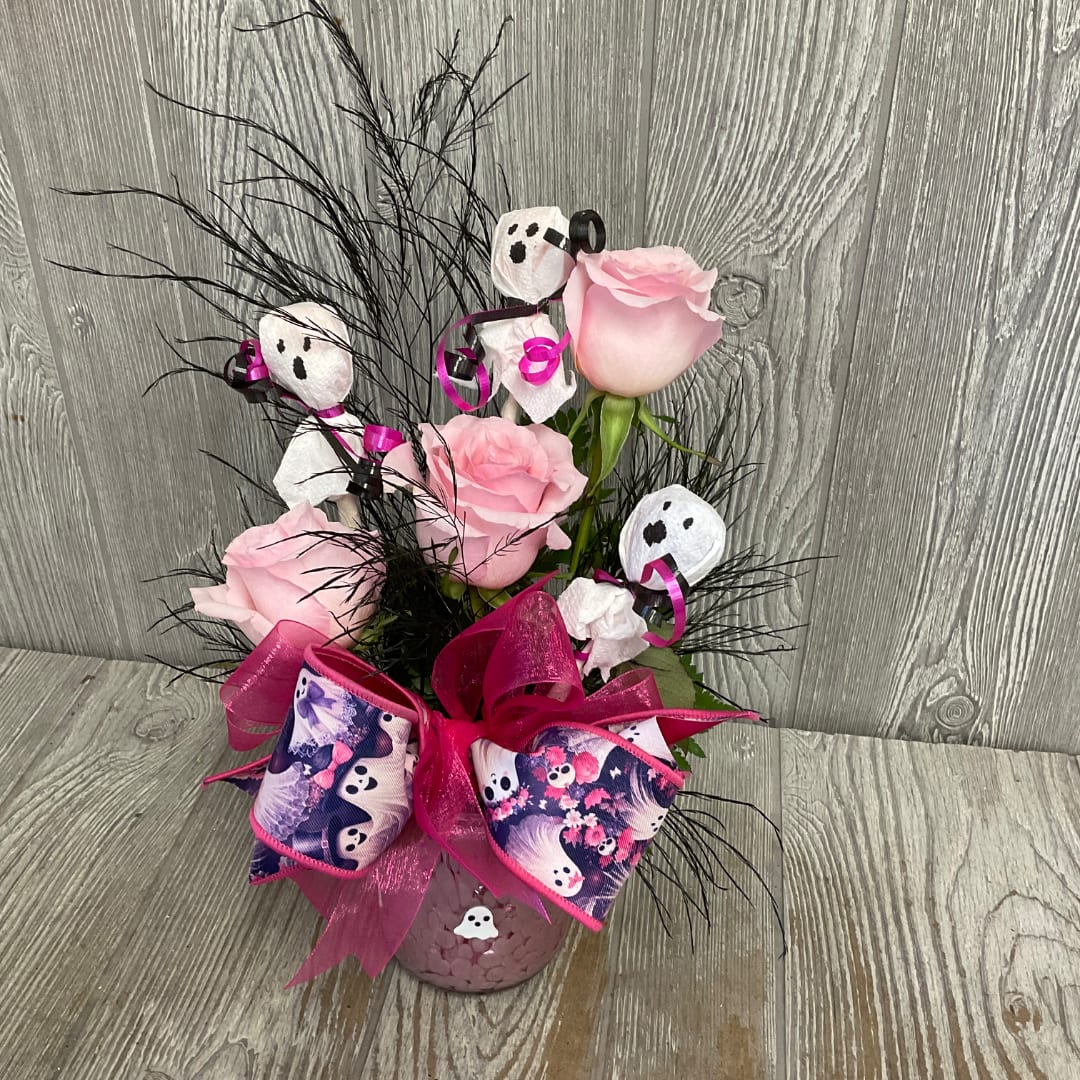 Pink roses in a pink vase with Halloween ghost decorations and ribbon