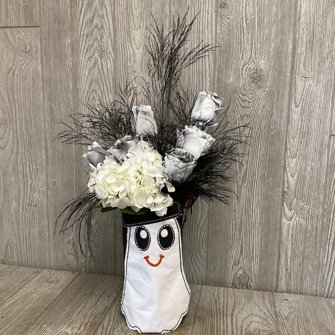 White roses and hydrangeas in a smiling ghost-shaped vase