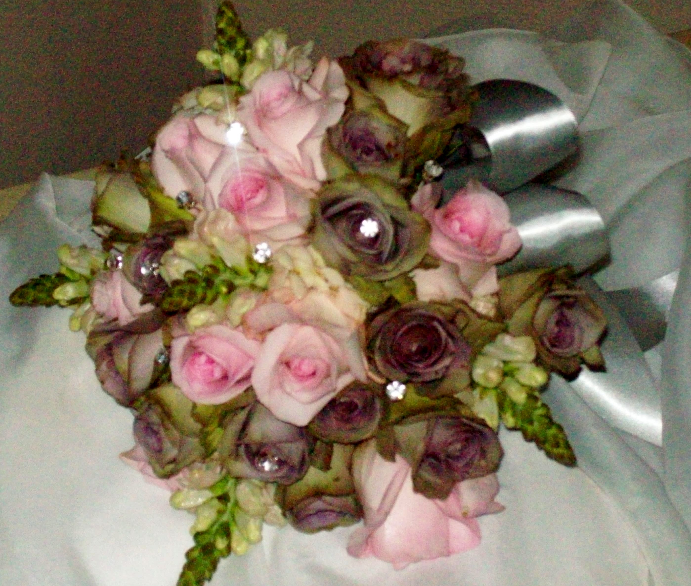 Bouquet of pink and purple roses with silver ribbon wrap