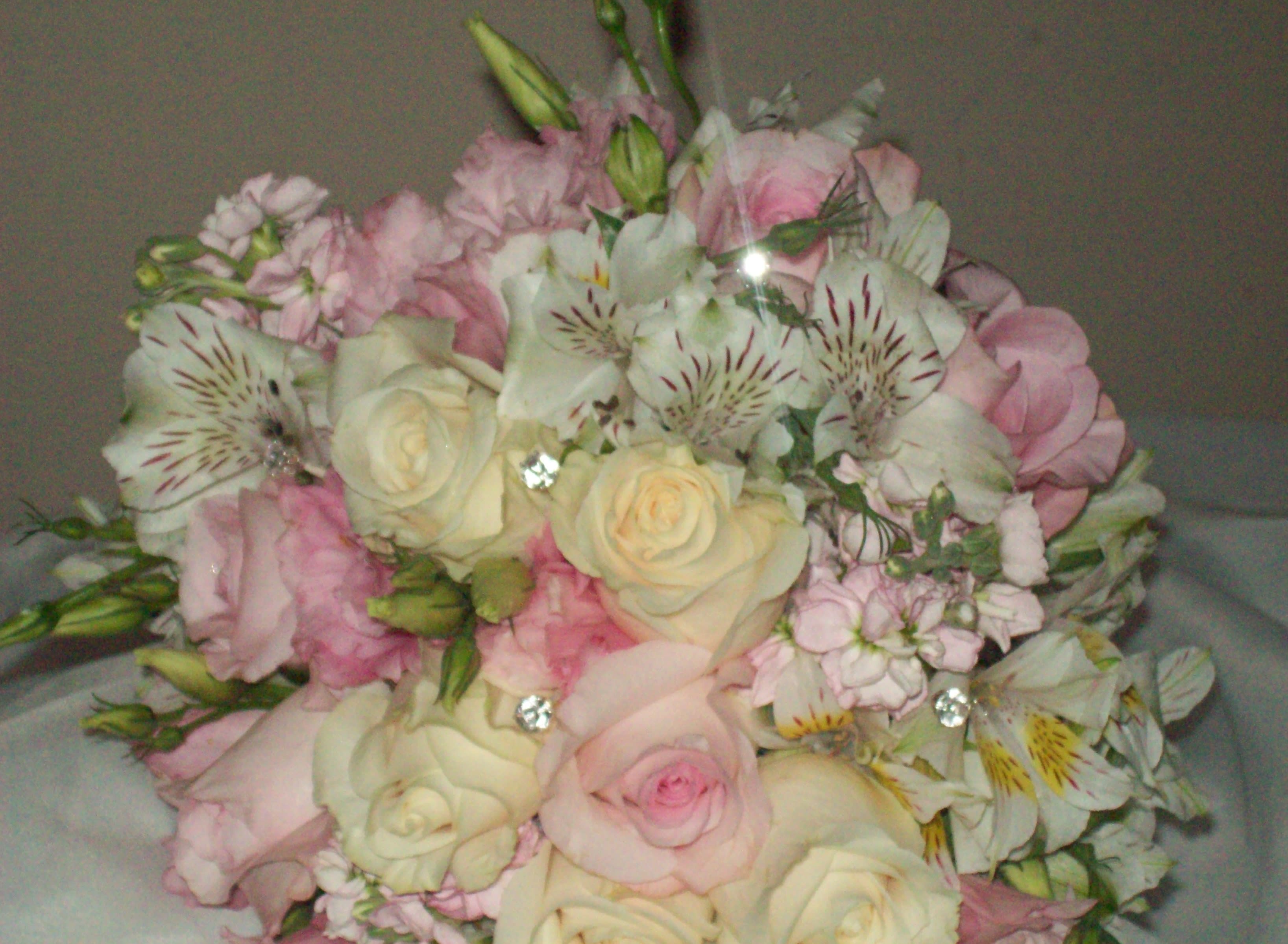 Bouquet of pale pink and cream roses with white striped alstroemeria