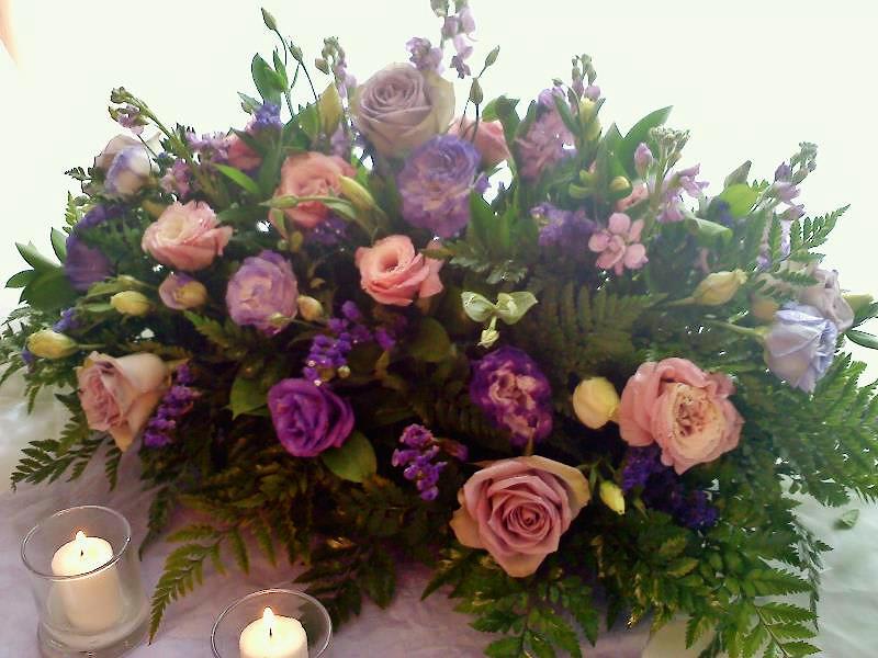 Large bouquet of pink and purple roses with candles