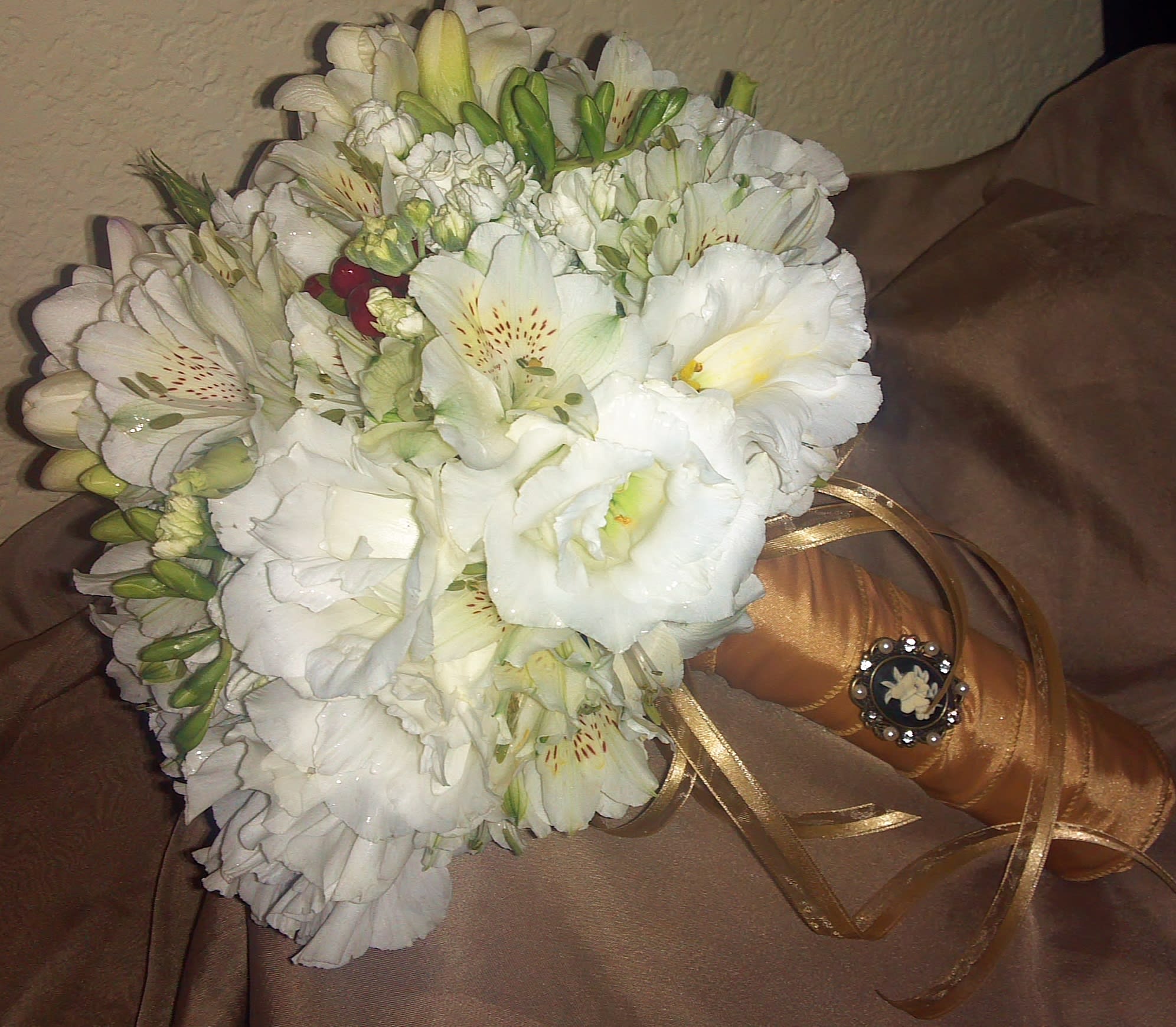 White flower bouquet with a gold ribbon-wrapped handle