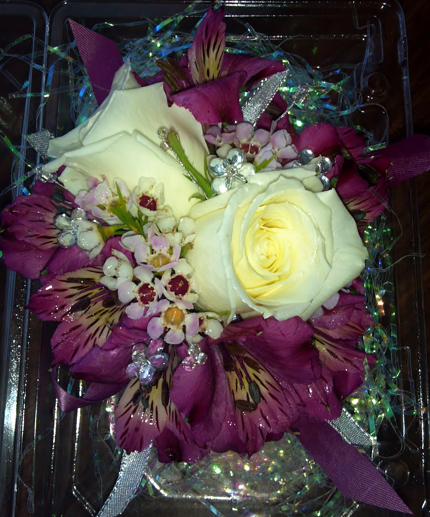 White roses with purple alstroemeria in a clear gift box