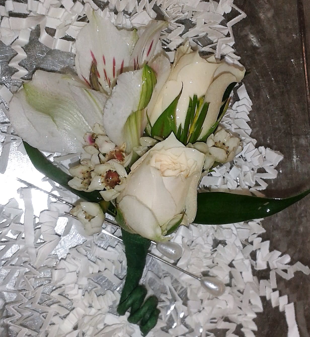 White rose and lily bouquet with small white filler flowers