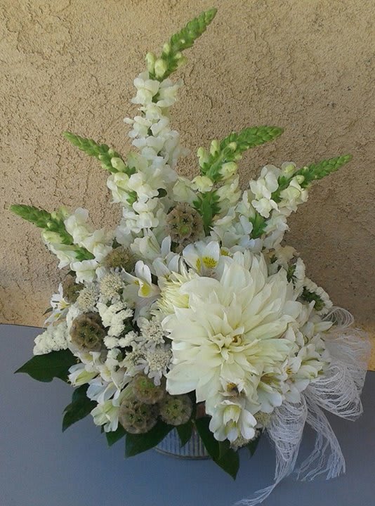 White floral arrangement with tall snapdragons and a large dahlia