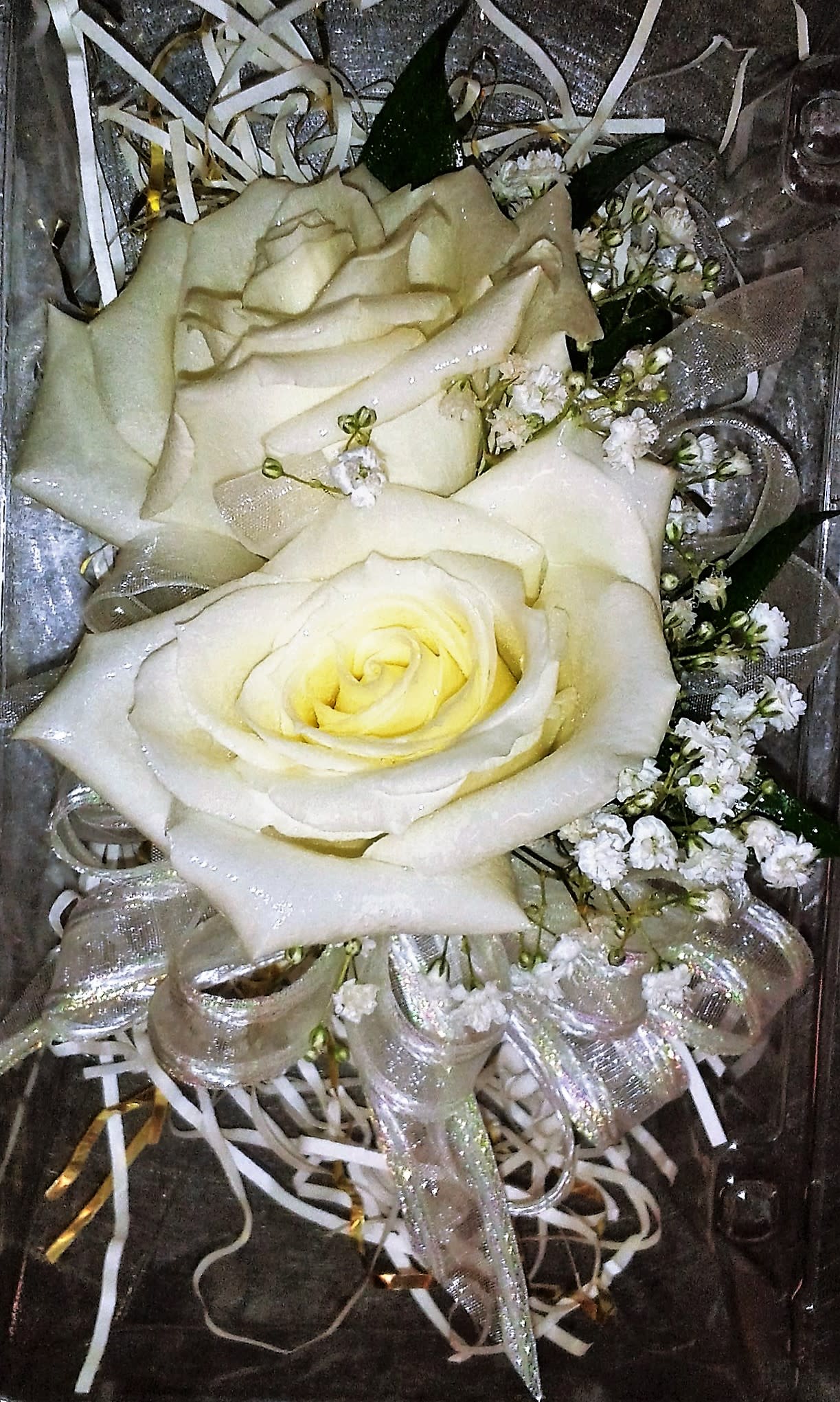 White roses with baby's breath and silver ribbon in a gift box