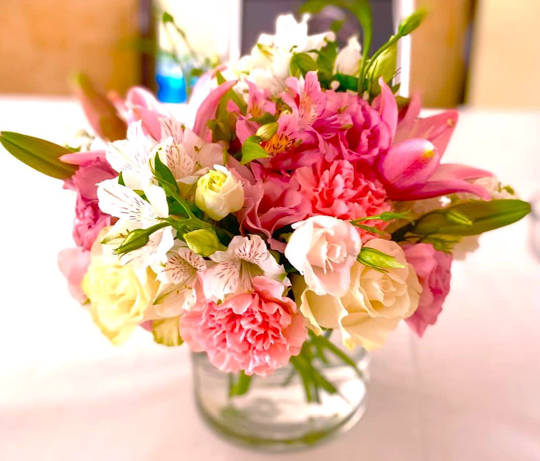 Pink and white mixed bouquet in a clear glass vase