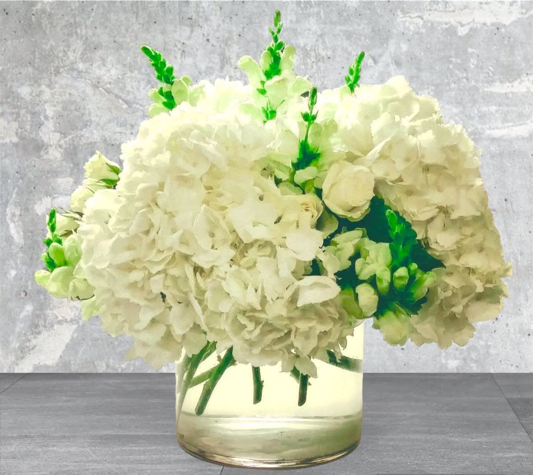 White hydrangea bouquet in a clear glass vase