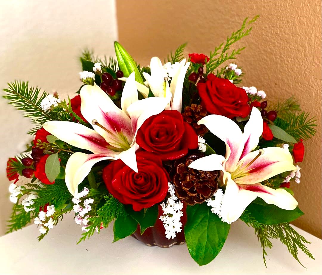 Red roses and white lilies arranged in a low vase