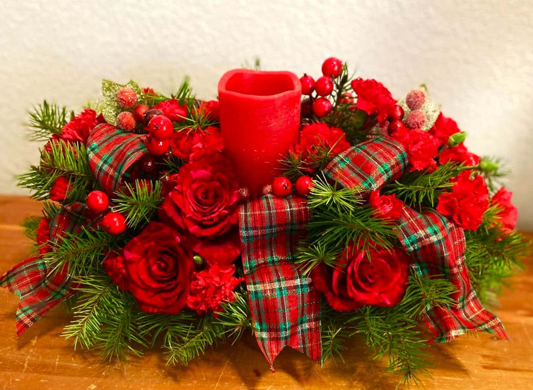 Red rose centerpiece with plaid ribbon and a red candle