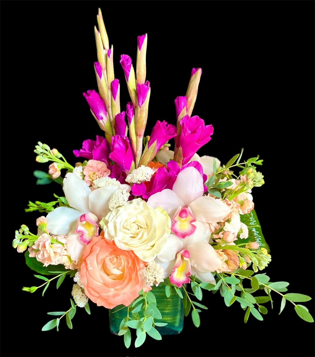 Mixed bouquet with pink and white flowers in a green vase