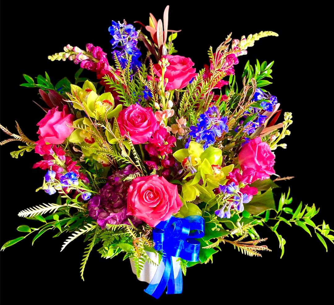Bright mixed bouquet of pink roses, blue flowers, and yellow orchids