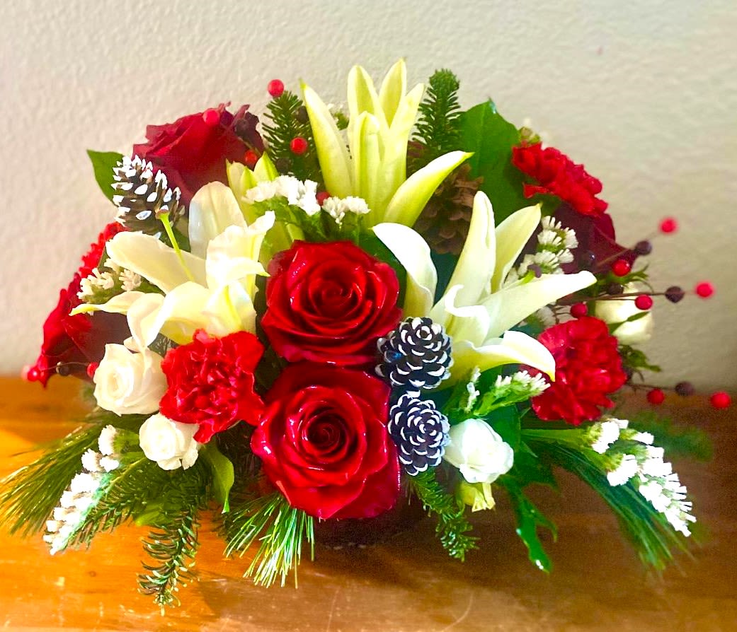 Red and white floral arrangement with lilies and roses