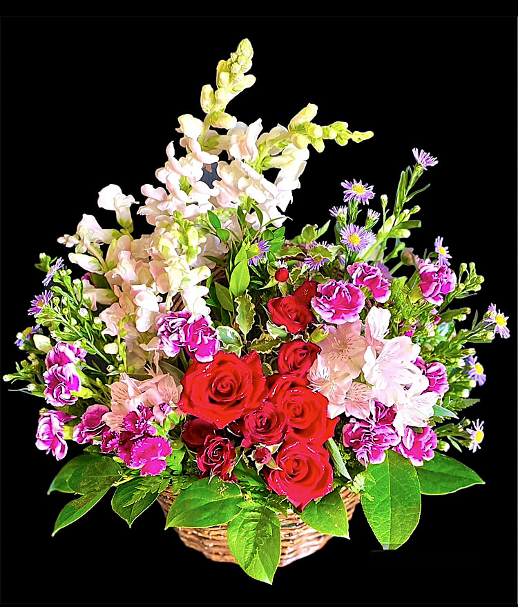 Basket of red roses, pink flowers, and purple daisies