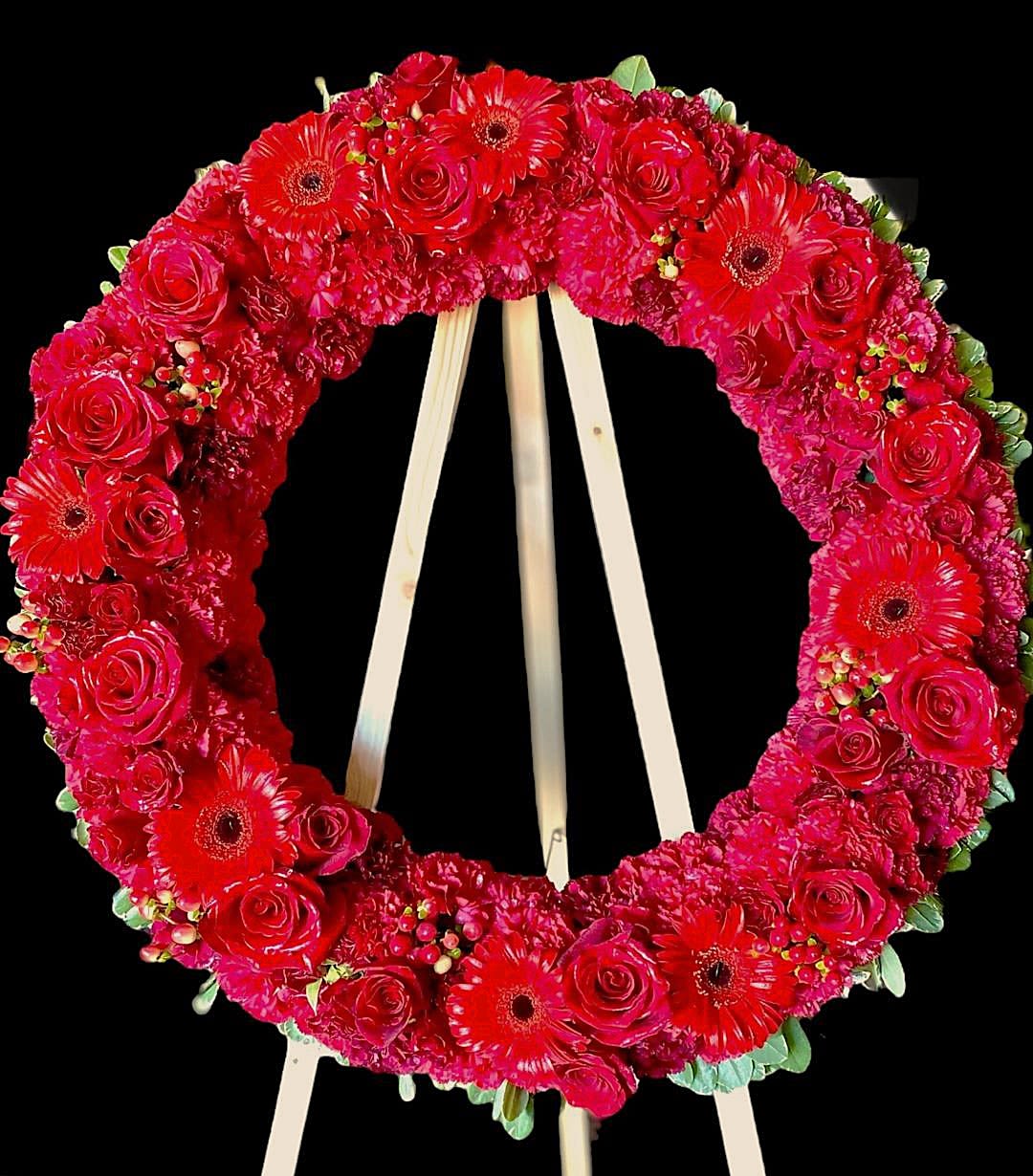 Red floral wreath on a wooden easel