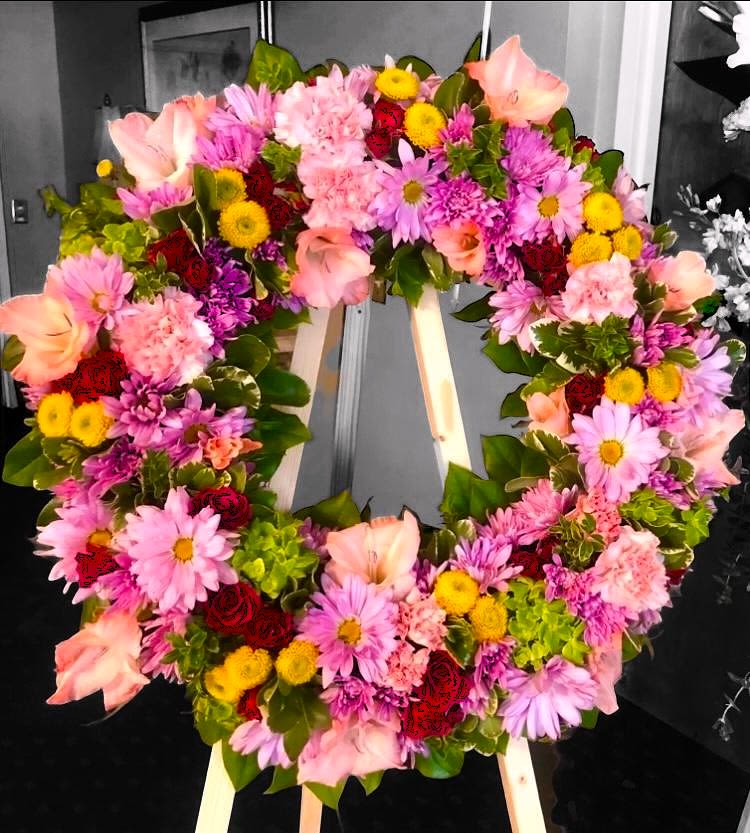 Heart-shaped floral wreath with pink, purple, yellow, and red blooms
