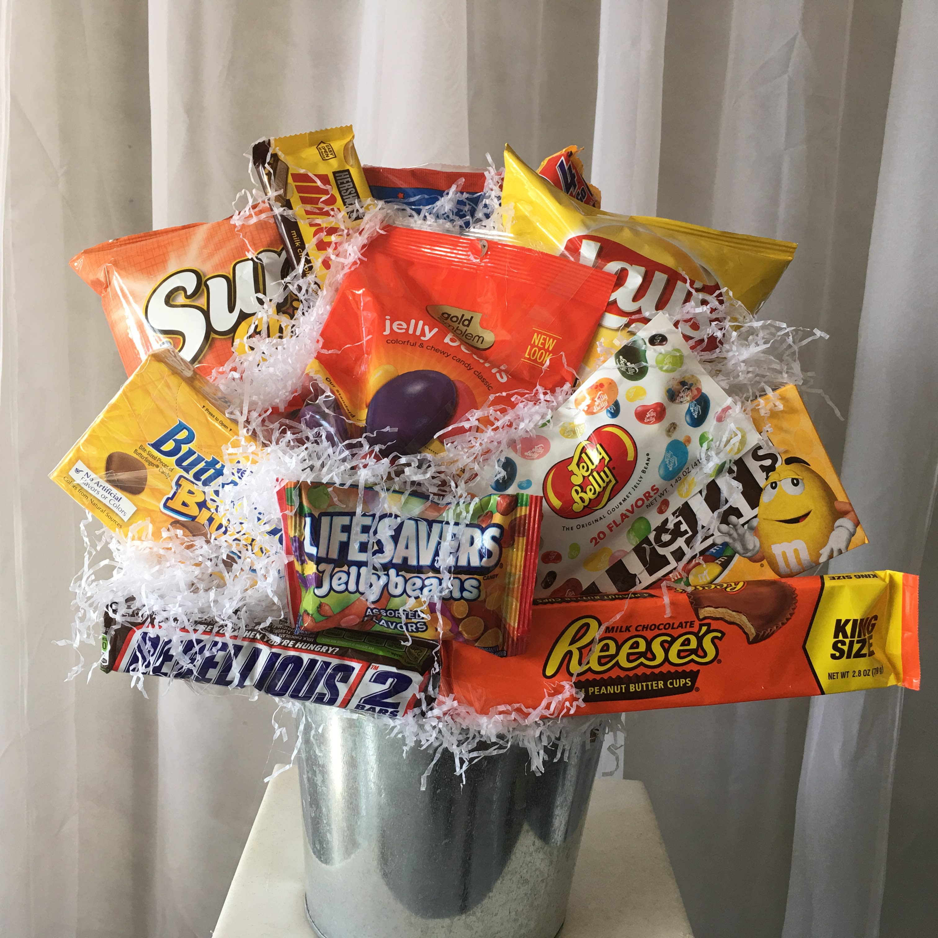 Junk Food Basket - This "Junk Food" Basket is great for any occasion! Send to a loved one as a thinking of you or send to a hungry college student to let them know you support them and wish them a great day. With everyone's favorite candies and chips, this basket is bound to be a hit! Due to items being sensitive to temperature, we will deliver once we know that someone is home.
