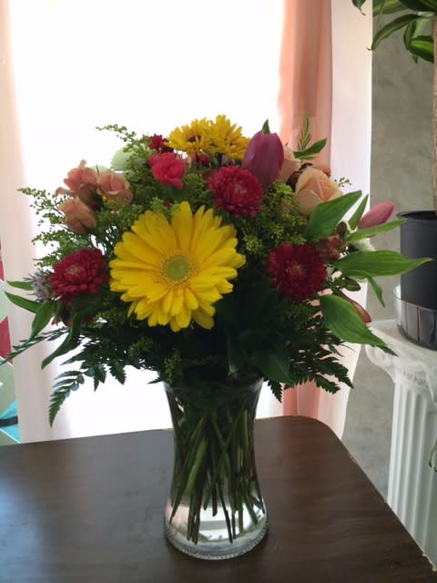 Lovely Mixed Bouquet - A lovely bouquet of mixed flowers hand-crafted and designed in a beautiful clear glass vase. A great mix that is great for Spring and Summer. Great for every occasion!  Please note: Tulips are no longer in season and will be replaced with roses.