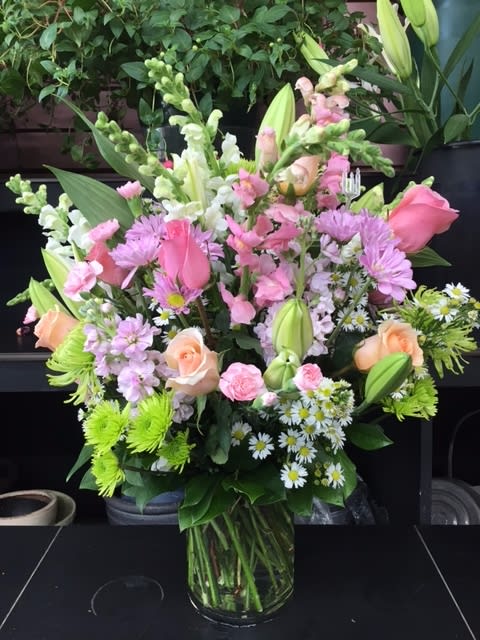 Grand Gesture Bouquet - This incredible pastel-like themed vase arrangement is sure to make a huge impression! The soft colors really stand out in their own magical way. The greens make it eye-popping, and the love and care that is put into it while designing will certainly shine through. This bouquet is the perfect way to say I Love You, Thank You, and it's really great for every occasion!